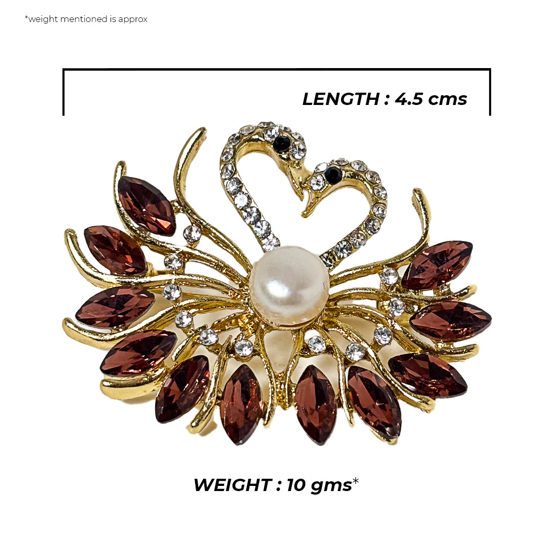 Close-up of a silver Hamsini Saree Pin adorned with intricate floral engraving and a small pearl accent.
