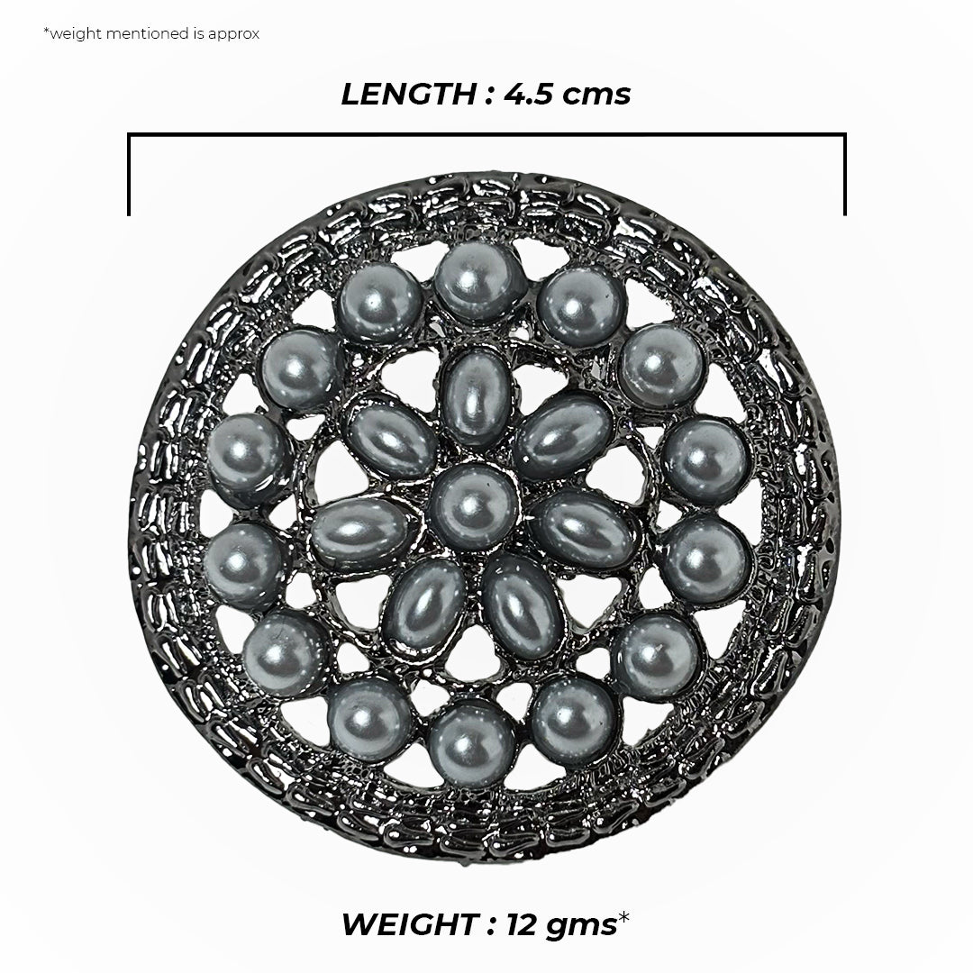Close-up of a silver Paridhi Saree Pin with intricate floral and leaf designs, sparkling subtly.