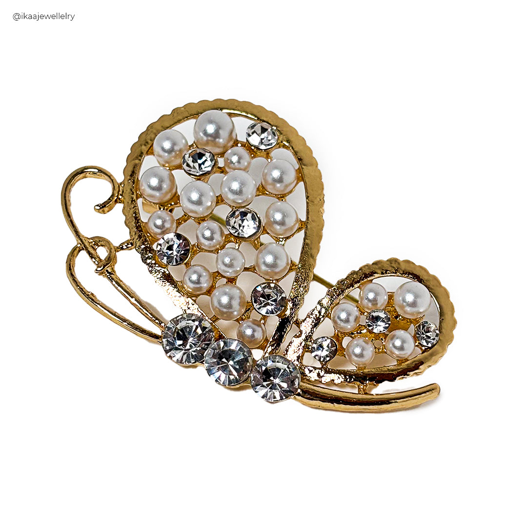 Close-up of a silver Titli Saree Pin with intricate butterfly wing details and a delicate pearl accent.