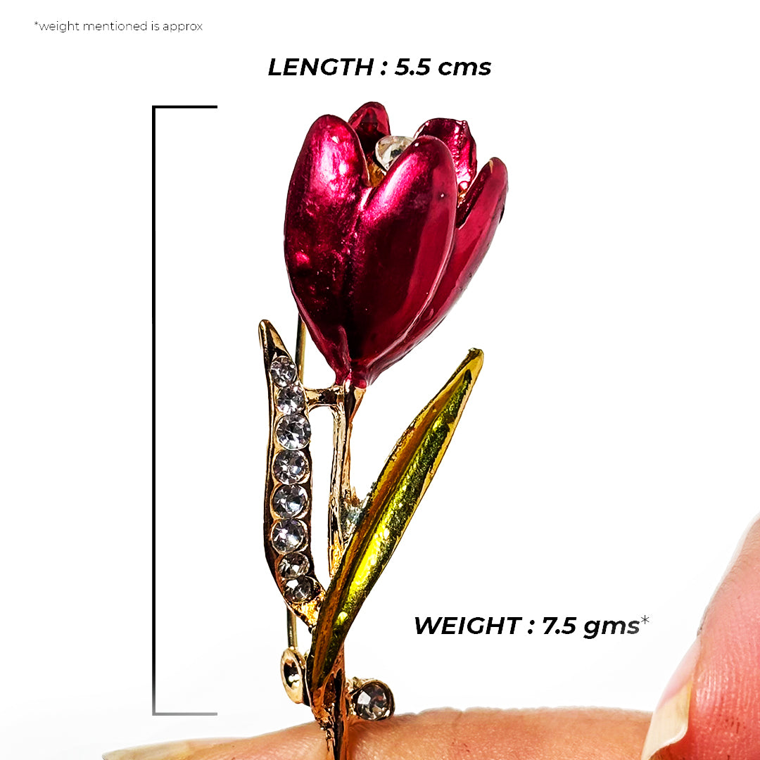 Arunika Saree Pin: A delicate gold-toned saree pin with intricate floral detailing and a central pearl.