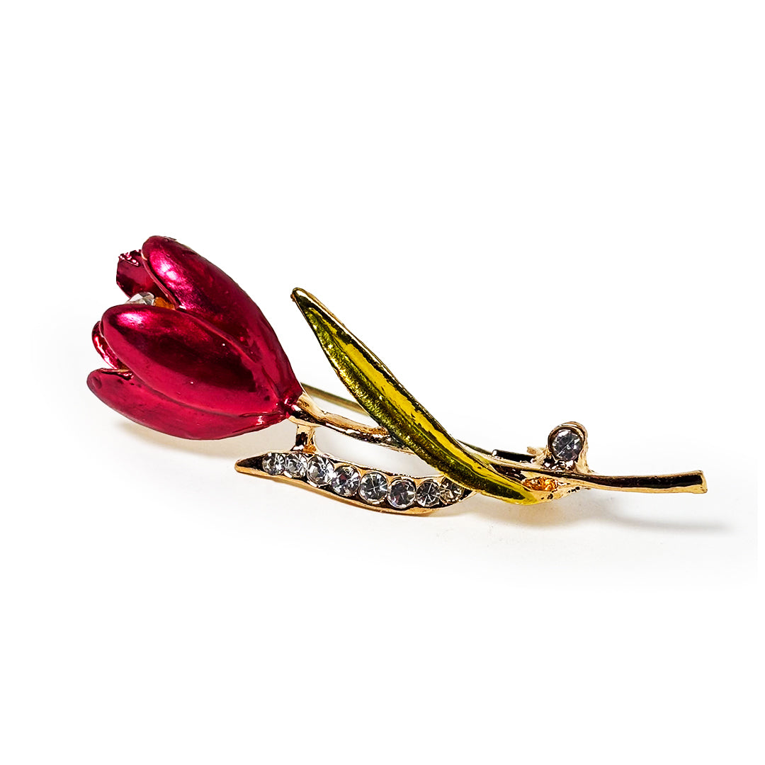 Arunika Saree Pin: A detailed close-up of a silver metal saree pin adorned with intricate floral patterns and a central