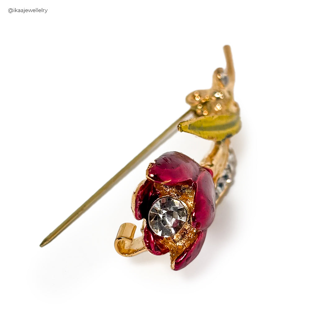 Close-up of the Arunika Saree Pin, a gold-toned floral brooch with intricate detailing and a central pearl.
