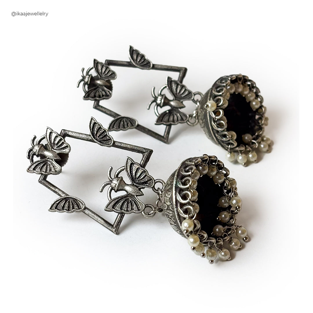 Close-up of Siya Earrings: delicate gold studs with intricate floral detailing, perfect for adding elegance.