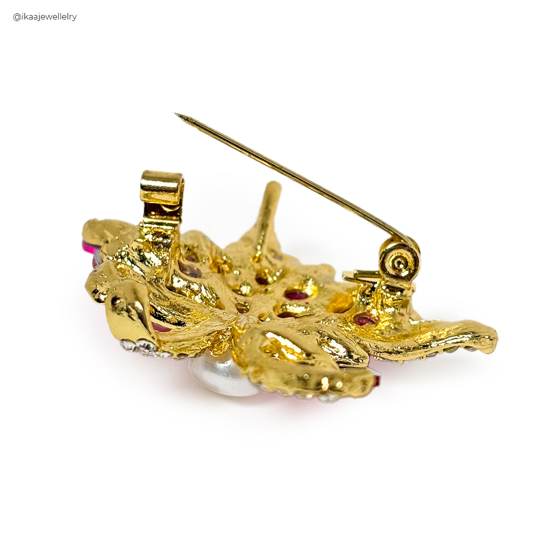 Close-up of the Ava Saree Pin, featuring intricate gold-toned floral embroidery on a dark fabric base.