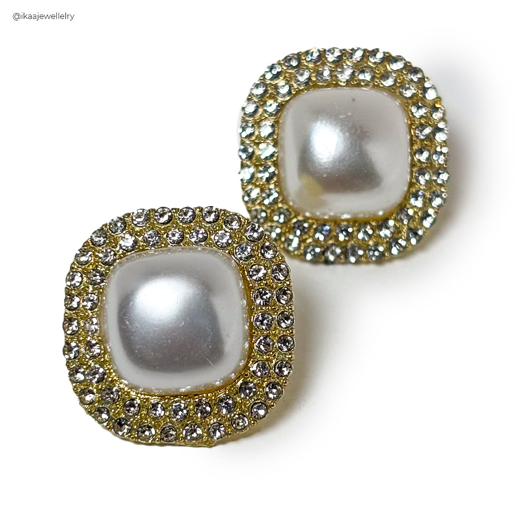 Close-up of Alina Pearl Earring featuring a lustrous pearl set in delicate gold.