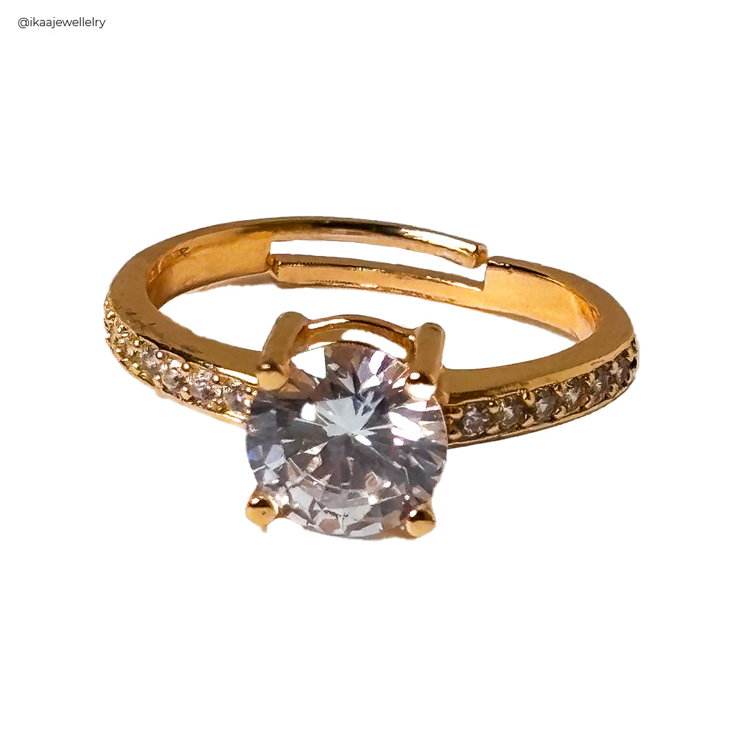 Close-up of the Lina Ring, a delicate gold band with a single small pearl at its center.