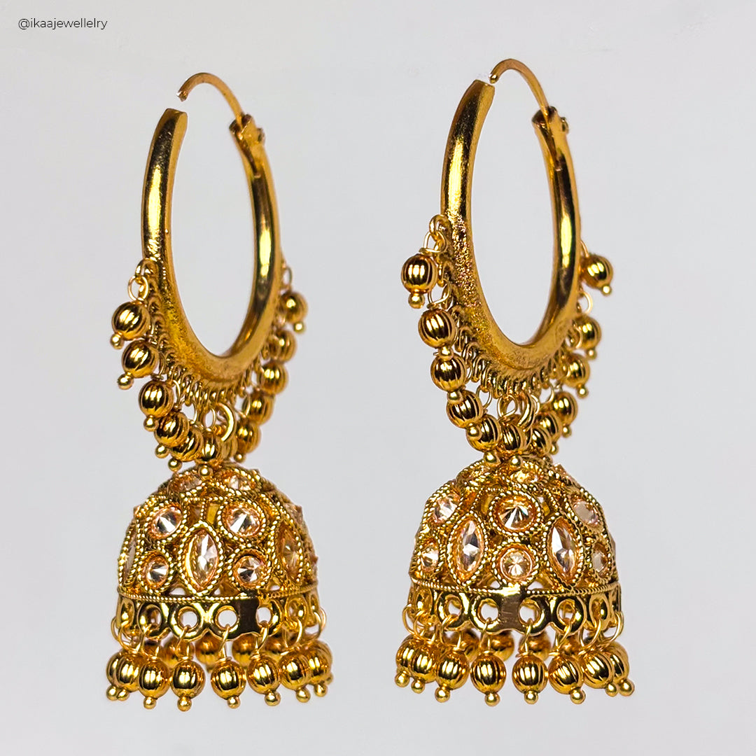 Elegant Sukanya Earrings with intricate gold detailing and a pearl drop, showcased against a white background.