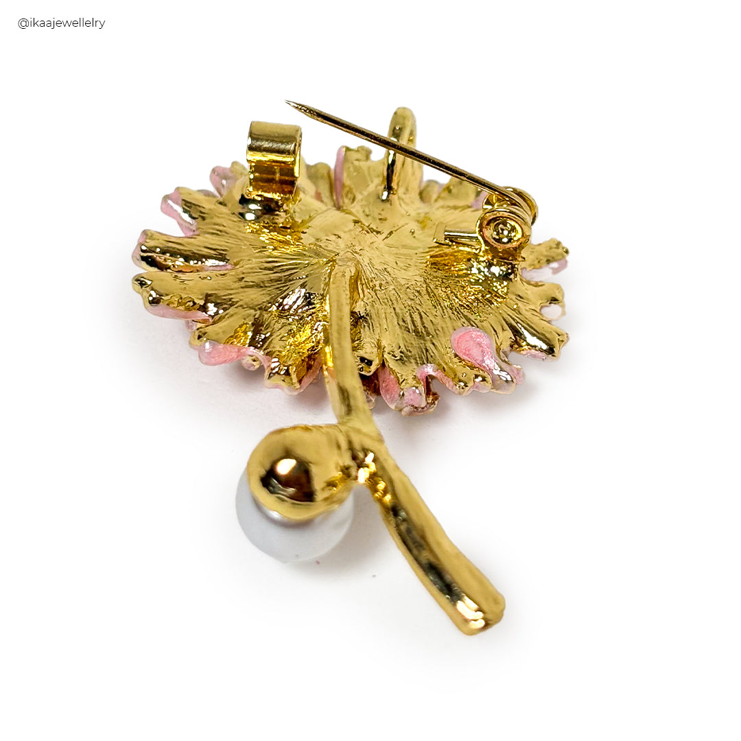Elegant Gulzaar Saree Pin with intricate floral and paisley gold metalwork on a white background.