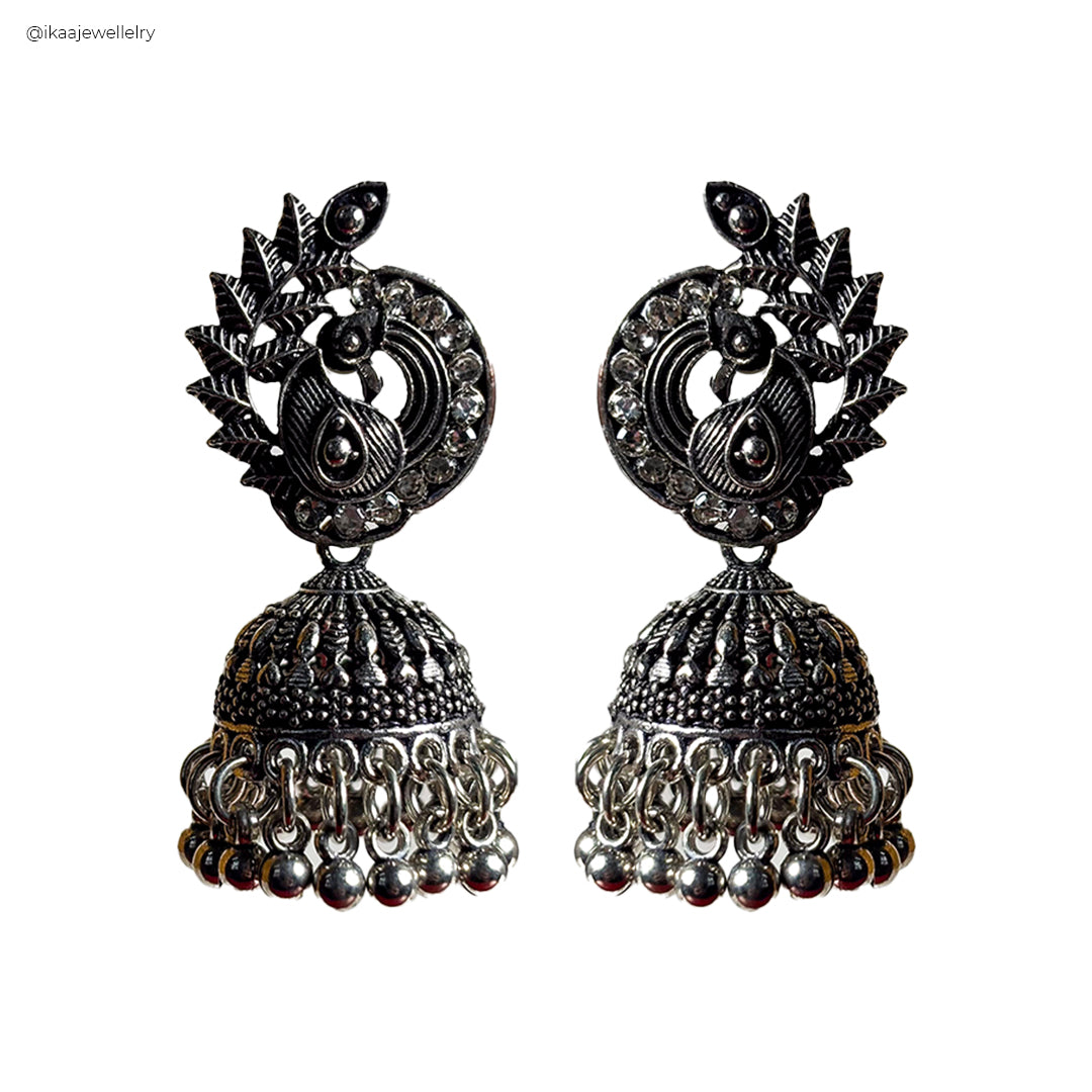 Elegant Vaidehi Earrings featuring intricate gold-toned metalwork with delicate pearl accents, showcased on a plain
