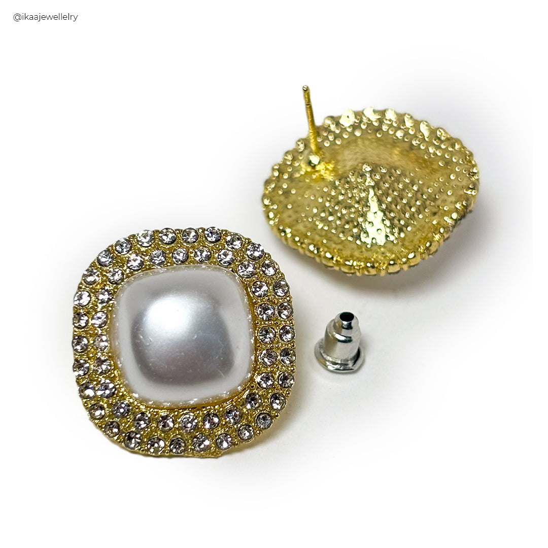Close-up of a single Alina Pearl Earring featuring a lustrous white pearl set in delicate gold.