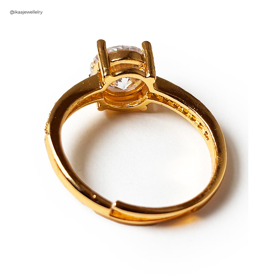 Close-up of the Lina Ring on a finger, showcasing its delicate gold band and prominent, sparkling gemstone.