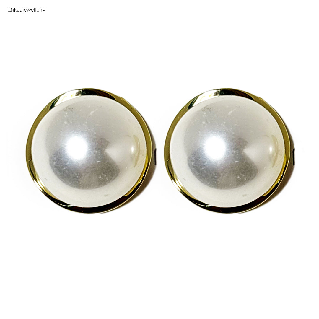 Close-up of the Ruva Earrings, showcasing their intricate gold-plated design with delicate pearl accents.