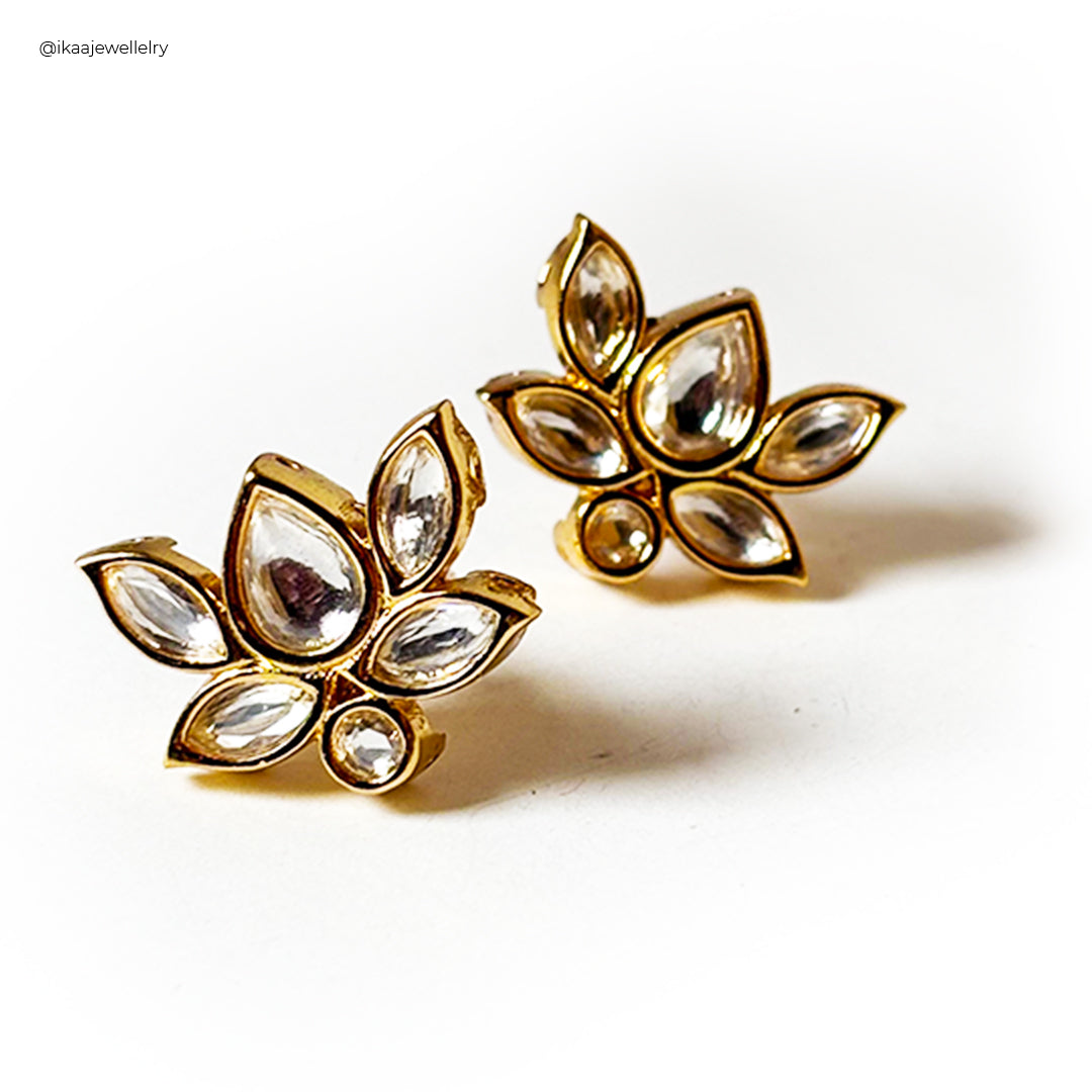 Close-up of Padma Earrings featuring delicate gold lotus flower designs with pearl accents.