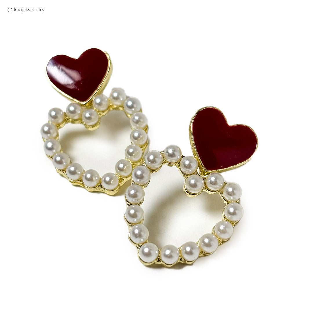 Close-up of Premika Earrings, featuring intricate gold filigree and a teardrop-shaped emerald stone.