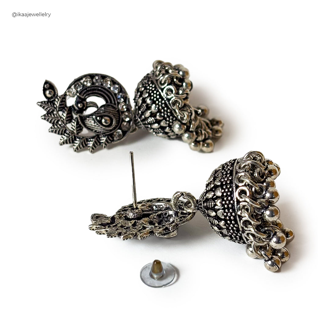 Close-up of Vaidehi Earrings, featuring intricate gold filigree work with pearl accents and a central ruby-like stone.