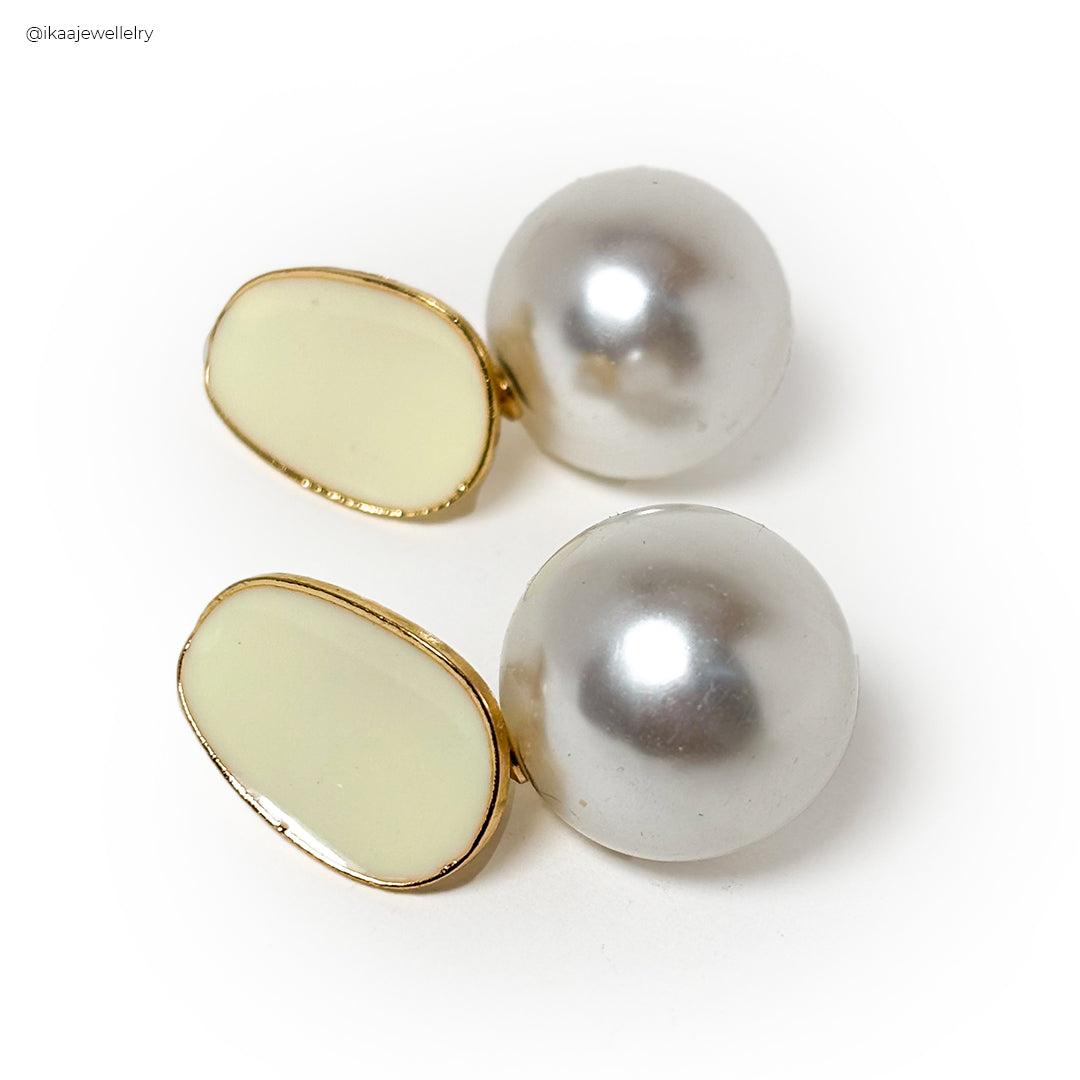 Mila Earrings: Delicate gold hoops with a small pearl drop, elegantly styled on a minimalist white background.