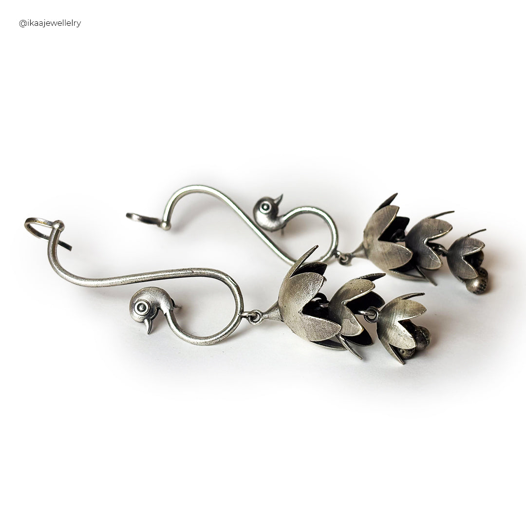 Mayuri Earcuffs: delicate gold-toned earcuffs with intricate floral and leaf details, elegantly framing an earlobe.