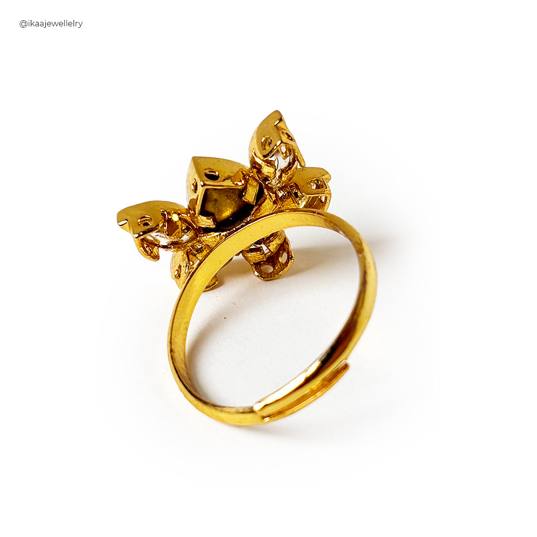 Close-up of the Padmika Ring, a gold band with a small, intricate floral design.