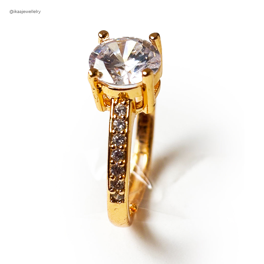 Close-up of the Lina Ring on a finger, showcasing its delicate gold band and a single, shimmering diamond.