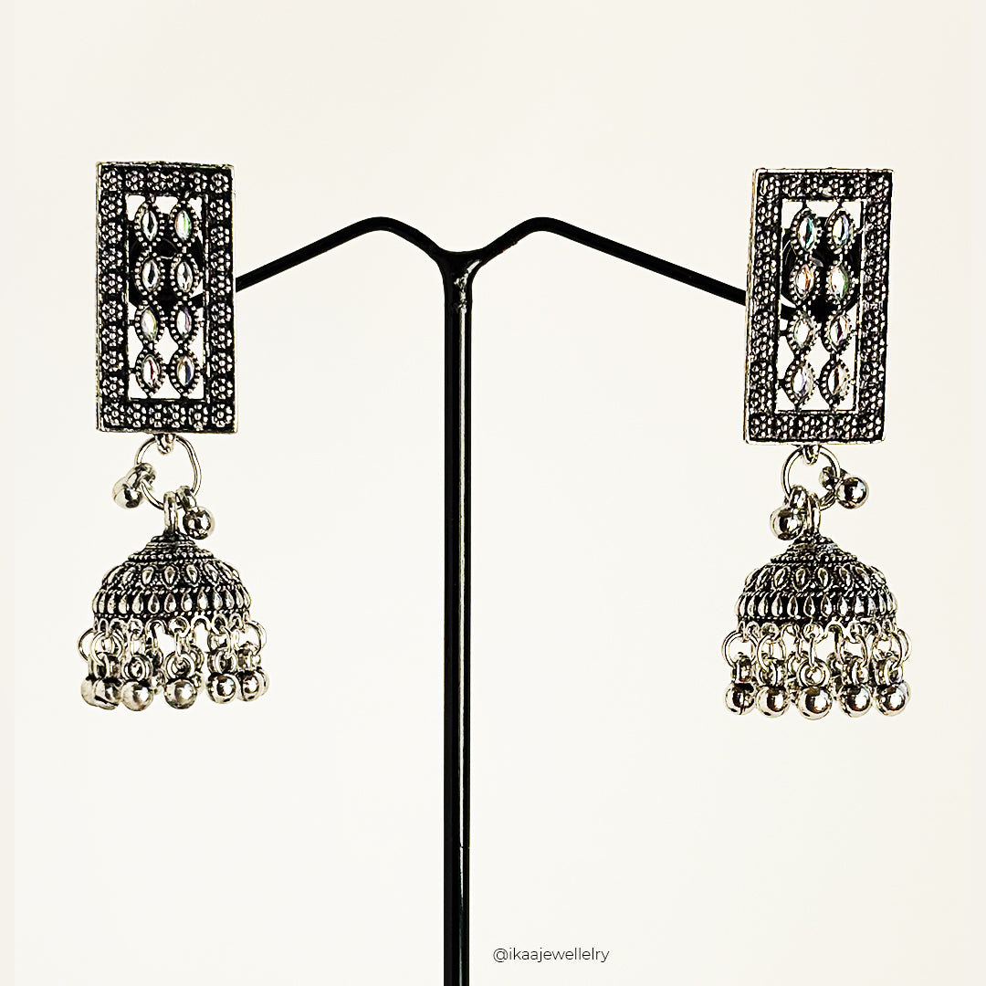 Aruna Jhumki Earrings: Traditional Indian gold-toned bell-shaped earrings with intricate floral carvings and dangling pearl