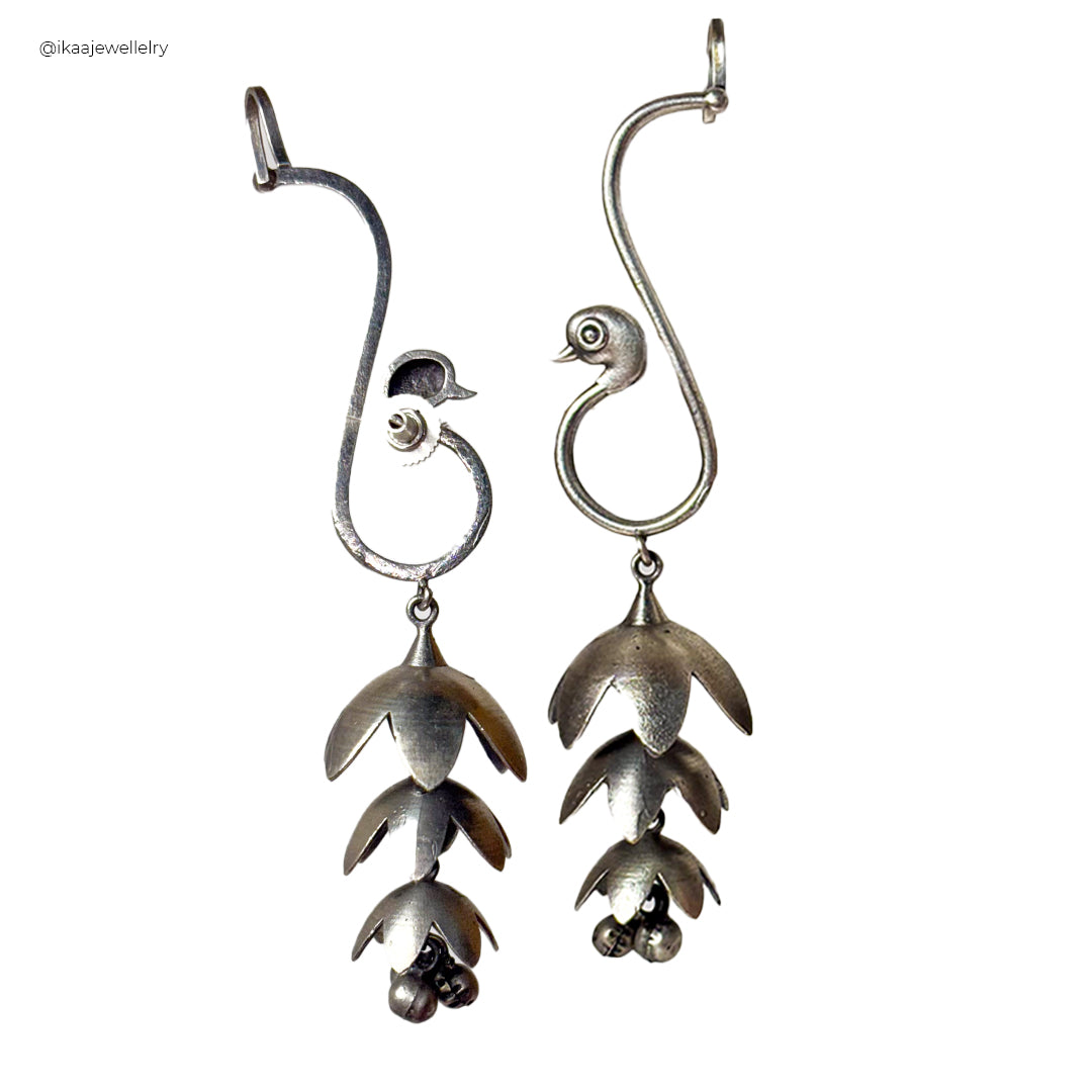 Mayuri Earcuffs in polished silver, delicately wrapping around an earlobe with a subtle, modern design.