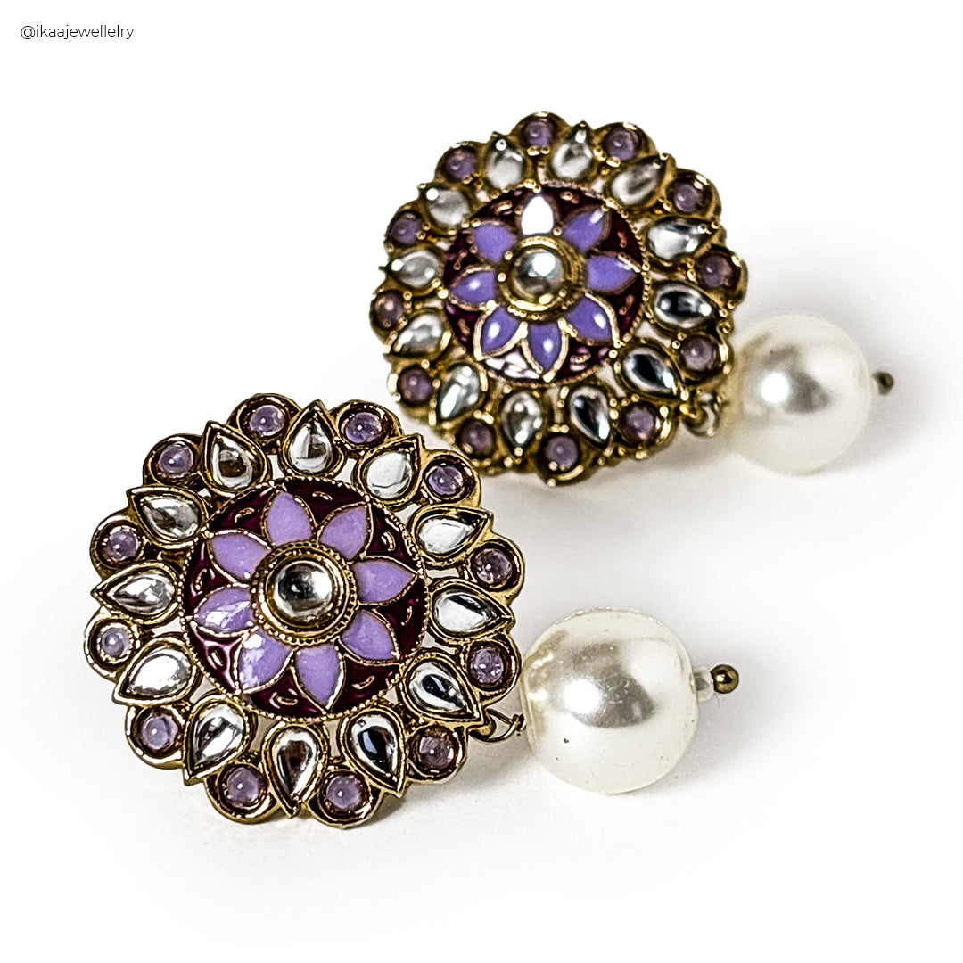 Juhi Pearl Drop Earrings: delicate pearl teardrops dangle from gold hooks, showcasing elegant simplicity.