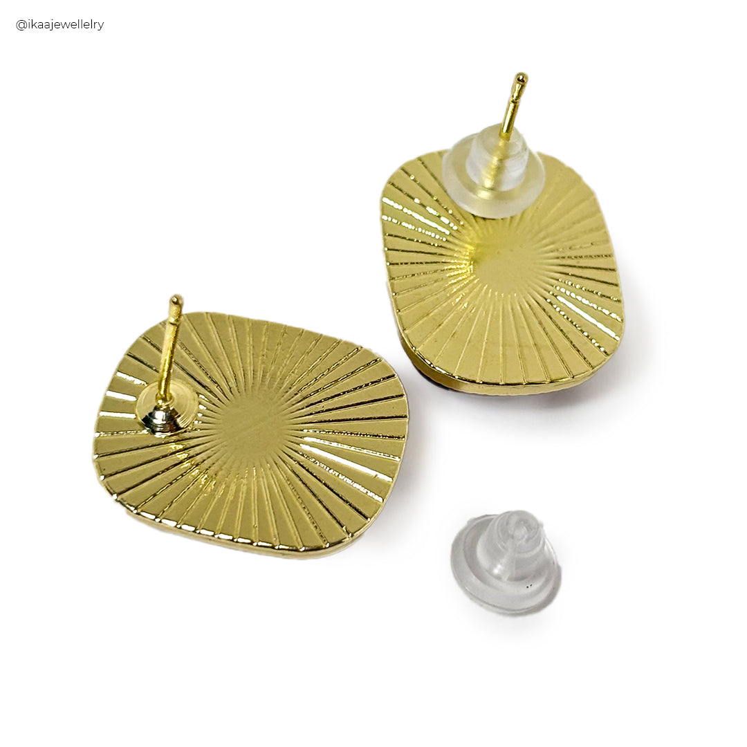 The Rhea Earrings are elegant gold drop earrings with a unique geometric design and delicate chain detailing.