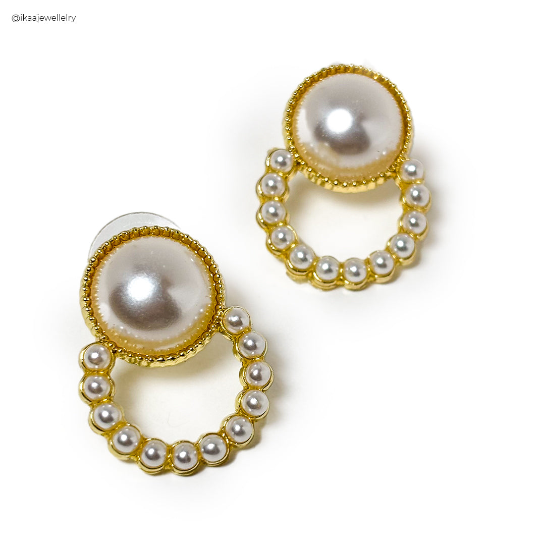 Close-up of the silver Riva Earrings, showcasing their intricate hammered texture and delicate dangle.