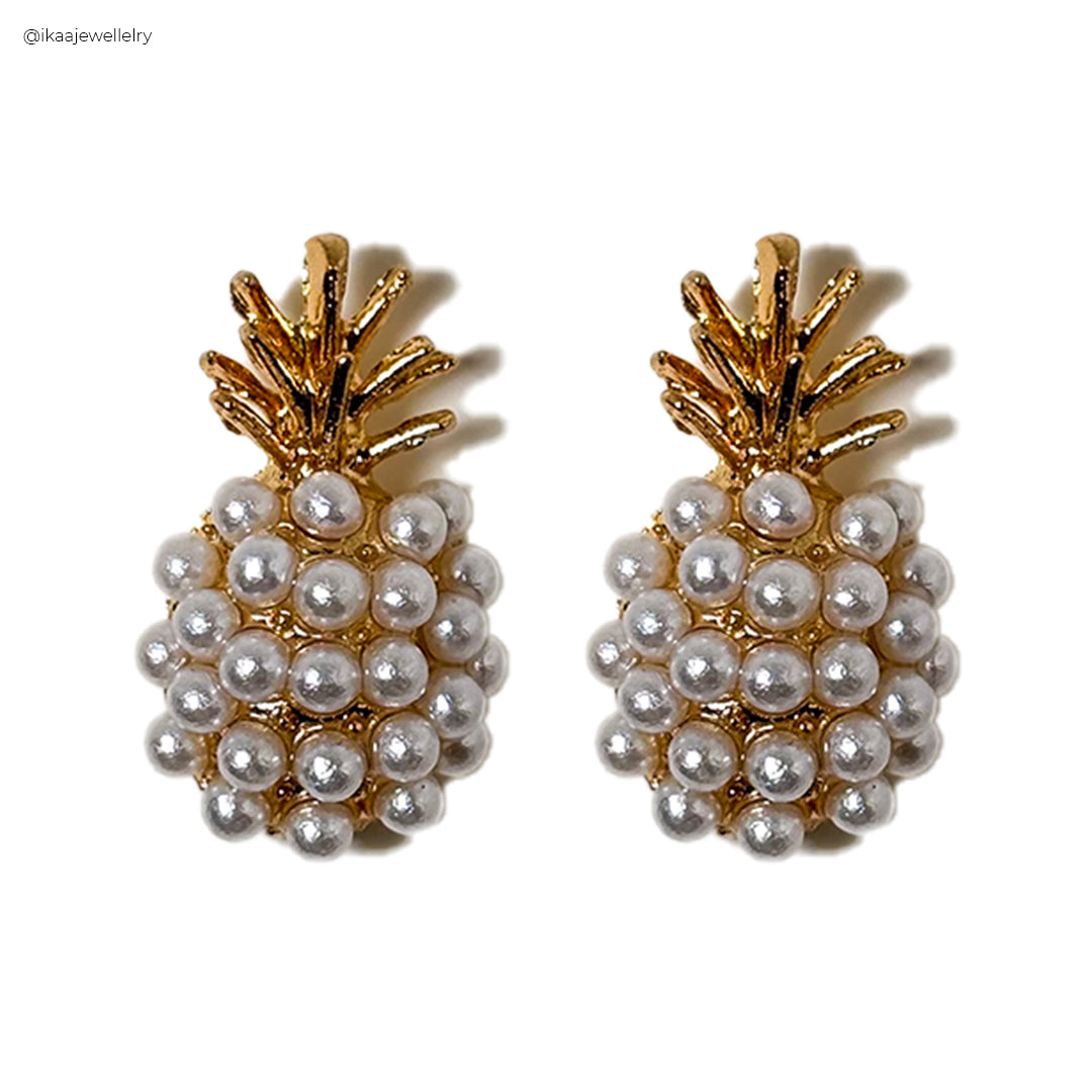 Delicate Pina Pearl Earrings featuring lustrous pearls suspended from gold-tone hooks, showcasing elegant simplicity.