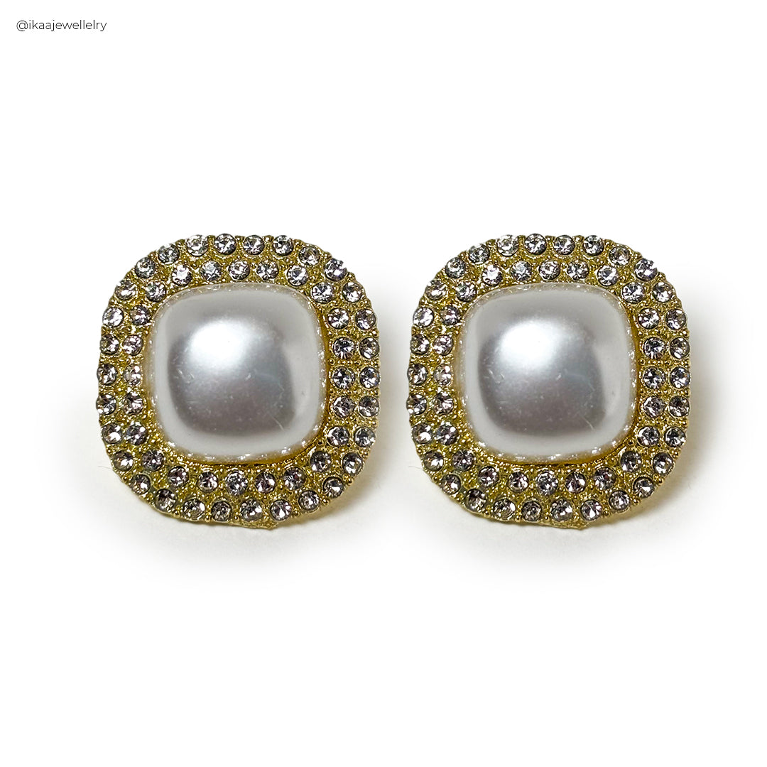 Close-up of the Alina Pearl Earring, showcasing a lustrous pearl set in delicate gold.
