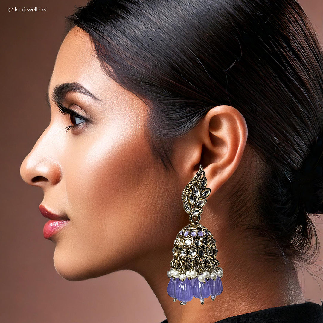 Malati Jhumka Earrings: intricate gold-toned bell-shaped earrings with pearl drops and delicate filigree work.
